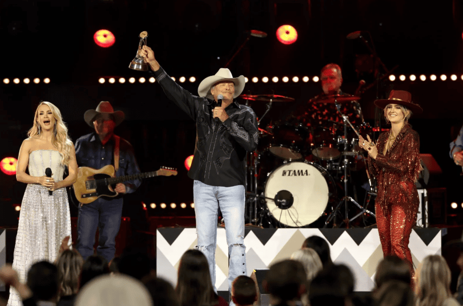 A live arena production combines award presentations with major musical performances
