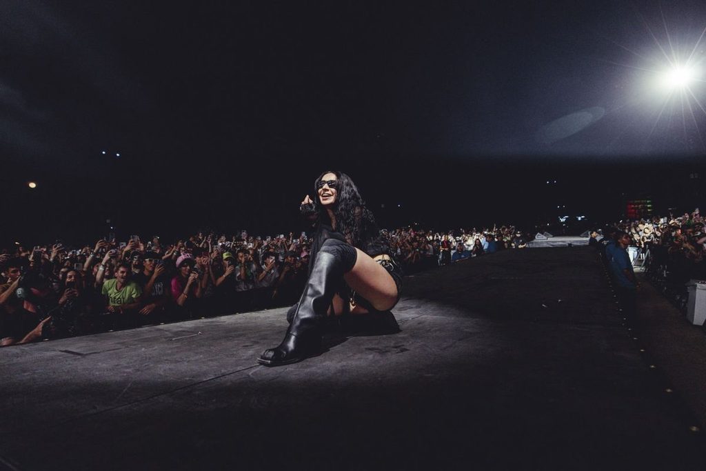Charli XCX performing live on stage